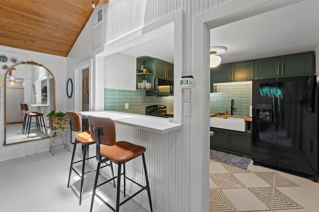 11302 Centennial Trl, Austin, TX 78726 - kitchen with black appliances, green cabinetry, wood ceiling, decorative backsplash, and high vaulted ceiling