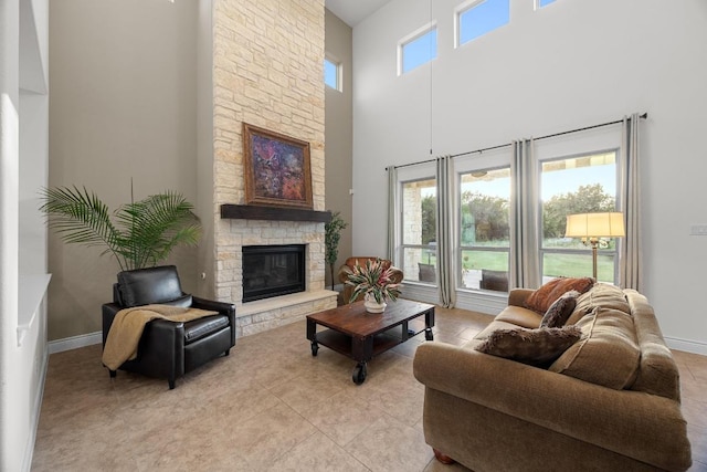 707 Campino Dr, Cedar Park, TX 78613 - living area featuring a high ceiling, a stone fireplace, and light tile patterned floors