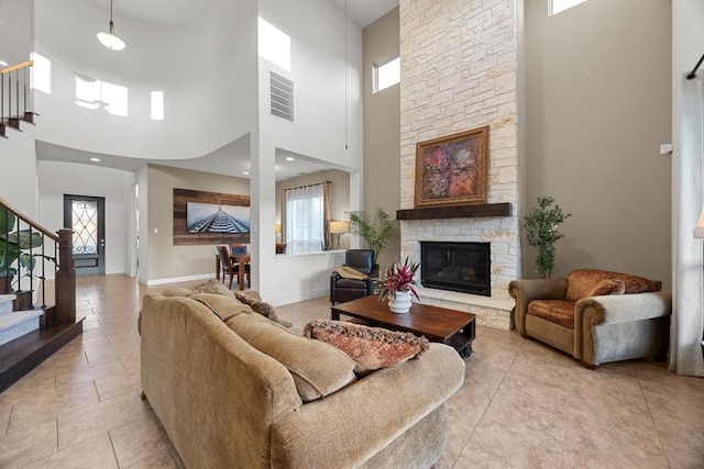 707 Campino Dr, Cedar Park, TX 78613 - living room with a high ceiling, stairs, plenty of natural light, and light tile patterned floors