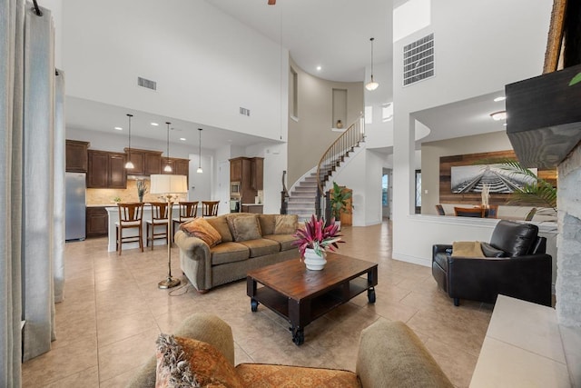 707 Campino Dr, Cedar Park, TX 78613 - living area featuring a towering ceiling, stairway, light tile patterned floors, and recessed lighting