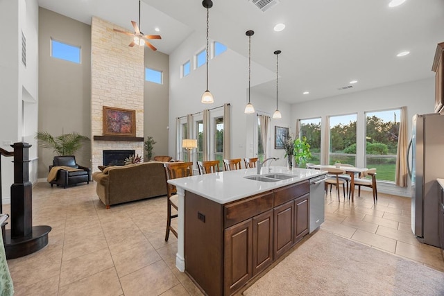 707 Campino Dr, Cedar Park, TX 78613 - kitchen featuring stainless steel appliances, a ceiling fan, light tile patterned floors, a breakfast bar area, and light countertops