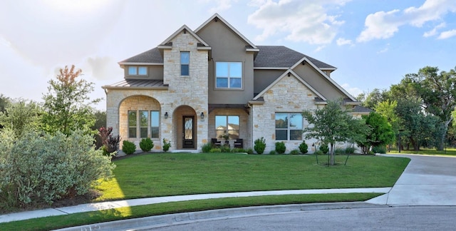 707 Campino Dr, Cedar Park, TX 78613 - view of front of home featuring stone siding, stucco siding, a standing seam roof, a front lawn, and a metal roof