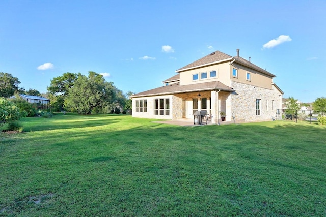 707 Campino Dr, Cedar Park, TX 78613 - back of house with stone siding, a lawn, and a patio area
