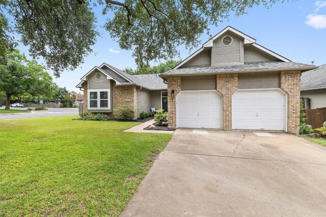 2901 Rochelle Dr, Austin, TX 78748 - view of front of home with brick siding, a front lawn, concrete driveway, and a garage
