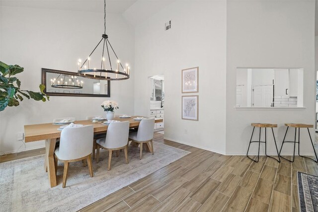 2901 Rochelle Dr, Austin, TX 78748 - dining room with high vaulted ceiling, a chandelier, and wood finished floors