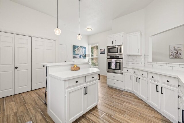2901 Rochelle Dr, Austin, TX 78748 - kitchen featuring stainless steel appliances, a center island, light countertops, and backsplash