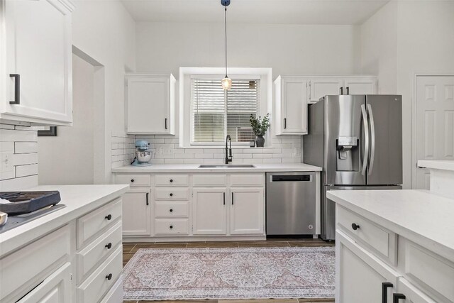 2901 Rochelle Dr, Austin, TX 78748 - kitchen featuring stainless steel appliances, decorative backsplash, white cabinetry, and light countertops
