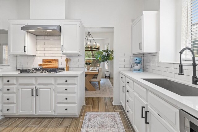 2901 Rochelle Dr, Austin, TX 78748 - kitchen featuring wood finish floors, tasteful backsplash, and light countertops