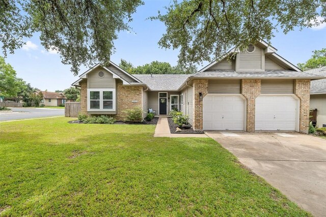 2901 Rochelle Dr, Austin, TX 78748 - view of front of house featuring brick siding, driveway, an attached garage, and a front lawn