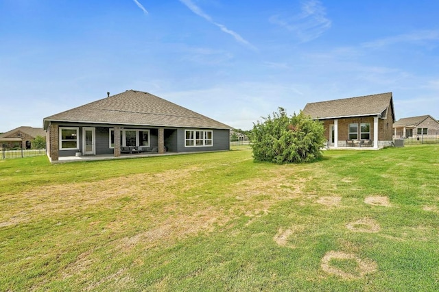 409 July Johnson Dr, Austin, TX 78737 - back of house with roof with shingles, a yard, a patio area, and brick siding
