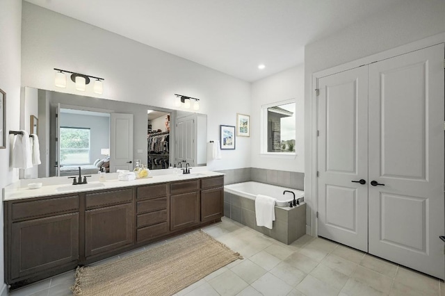 409 July Johnson Dr, Austin, TX 78737 - full bathroom with a bath, tile patterned floors, double vanity, and a walk in closet