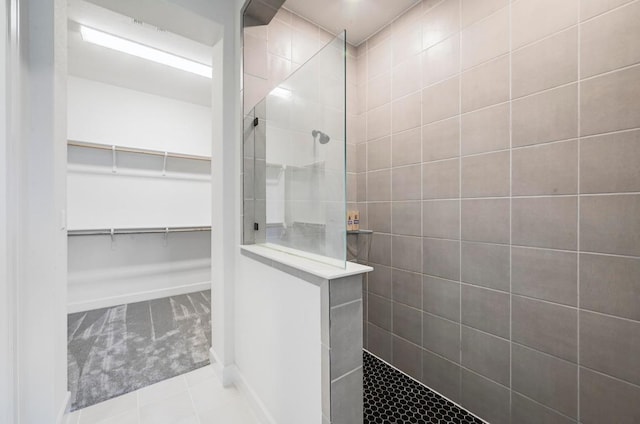 409 July Johnson Dr, Austin, TX 78737 - bathroom with walk in shower, a spacious closet, and tile patterned floors