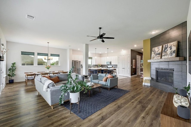 409 July Johnson Dr, Austin, TX 78737 - living room featuring dark wood-style flooring, ceiling fan, a tile fireplace, and recessed lighting