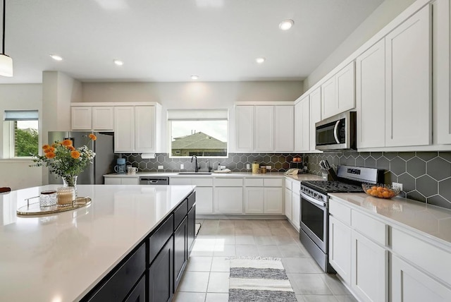 409 July Johnson Dr, Austin, TX 78737 - kitchen with stainless steel appliances, white cabinets, plenty of natural light, and recessed lighting