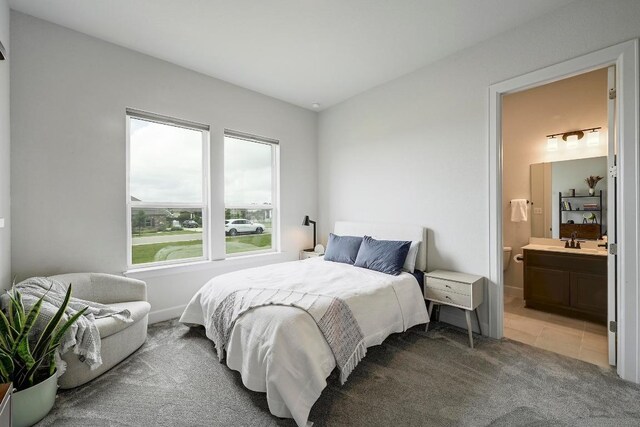 409 July Johnson Dr, Austin, TX 78737 - bedroom featuring light colored carpet and ensuite bath