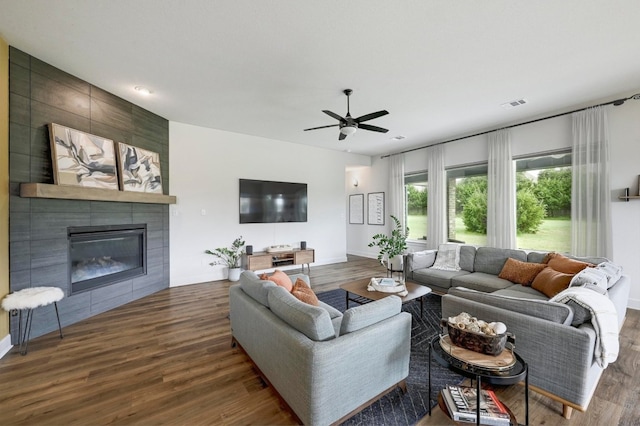 409 July Johnson Dr, Austin, TX 78737 - living area featuring wood finished floors, ceiling fan, and a tiled fireplace