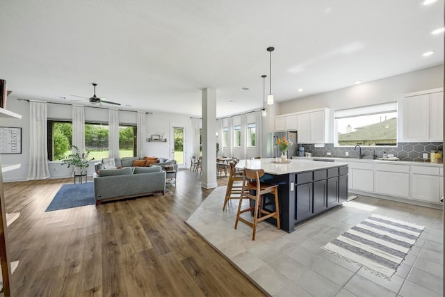 409 July Johnson Dr, Austin, TX 78737 - kitchen with plenty of natural light, a center island, white cabinets, and recessed lighting