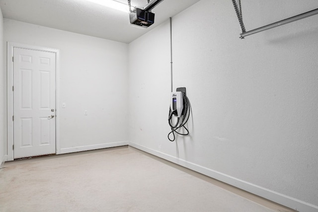 409 July Johnson Dr, Austin, TX 78737 - garage featuring electric vehicle charger and a garage door opener