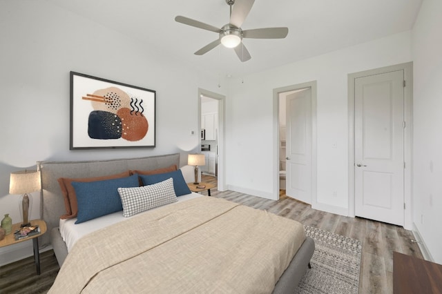 409 July Johnson Dr, Austin, TX 78737 - bedroom featuring light wood finished floors, a ceiling fan, and connected bathroom