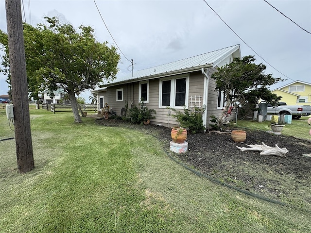 549 Marshall Johnson Ave S, Port Lavaca, TX 77979 - view of side of home with a lawn and a metal roof