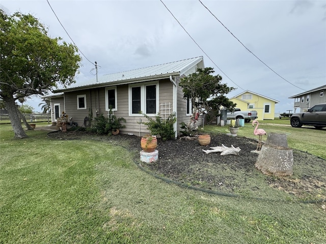 549 Marshall Johnson Ave S, Port Lavaca, TX 77979 - view of property exterior featuring a lawn and a metal roof