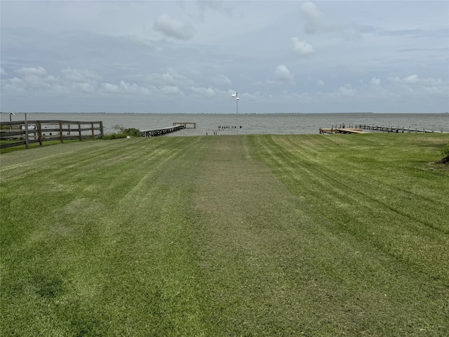 549 Marshall Johnson Ave S, Port Lavaca, TX 77979 - view of green lawn with a water view and a dock