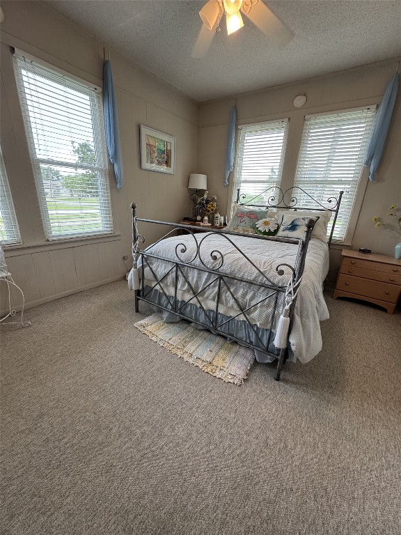 549 Marshall Johnson Ave S, Port Lavaca, TX 77979 - carpeted bedroom with a textured ceiling and ceiling fan
