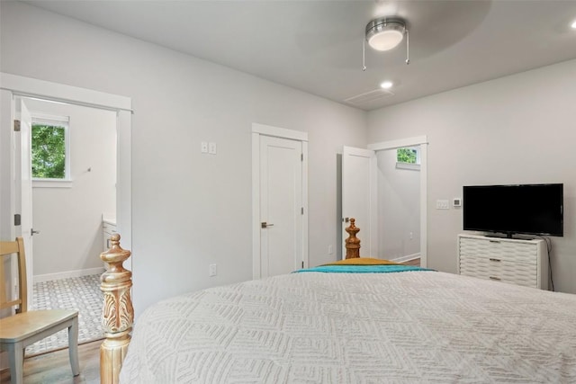 1125 Tillery St Unit 1A, Austin, TX 78702 - bedroom featuring multiple windows, ceiling fan, wood finished floors, and recessed lighting