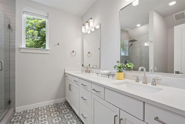 1125 Tillery St Unit 1A, Austin, TX 78702 - full bathroom featuring double vanity, a shower stall, recessed lighting, and tile patterned floors