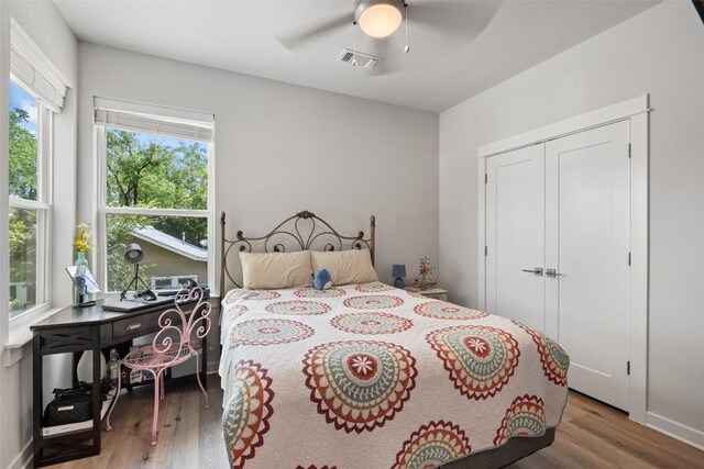1125 Tillery St Unit 1A, Austin, TX 78702 - bedroom featuring wood finished floors, ceiling fan, and a closet