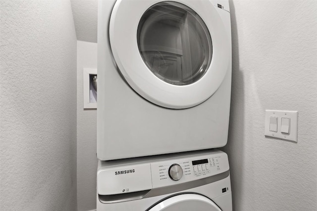1125 Tillery St Unit 1A, Austin, TX 78702 - washroom featuring stacked washer / drying machine and a textured wall
