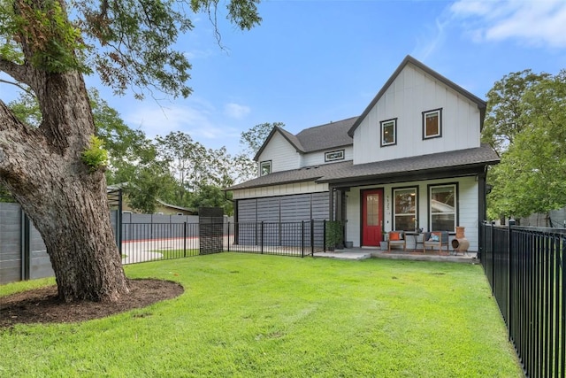1125 Tillery St Unit 1A, Austin, TX 78702 - rear view of property with covered porch, board and batten siding, and a shingled roof