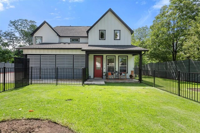 1125 Tillery St Unit 1A, Austin, TX 78702 - view of front facade with board and batten siding, covered porch, a shingled roof, and a fenced backyard