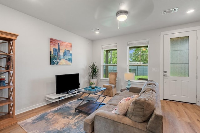 1125 Tillery St Unit 1A, Austin, TX 78702 - living room with wood finished floors, a ceiling fan, and recessed lighting