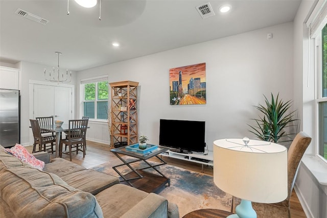 1125 Tillery St Unit 1A, Austin, TX 78702 - living area featuring wood finished floors, a chandelier, and recessed lighting