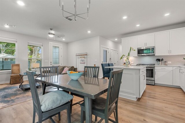 1125 Tillery St Unit 1A, Austin, TX 78702 - dining space with light wood-style floors, recessed lighting, and a chandelier