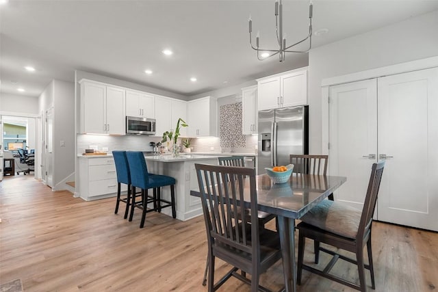 1125 Tillery St Unit 1A, Austin, TX 78702 - dining space featuring recessed lighting, light wood-style floors, and a chandelier
