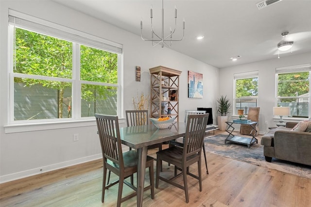 1125 Tillery St Unit 1A, Austin, TX 78702 - dining space with light wood-style floors, healthy amount of natural light, a chandelier, and recessed lighting