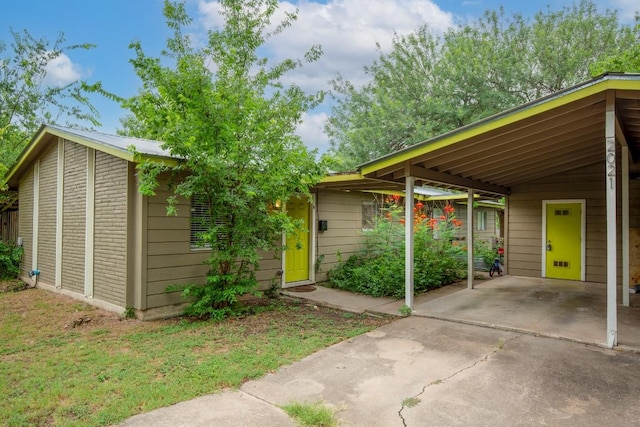 2021 Wheless Ln, Austin, TX 78723 - view of parking with concrete driveway and a carport