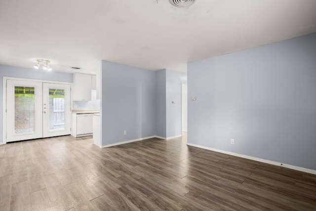 2021 Wheless Ln, Austin, TX 78723 - unfurnished living room featuring wood finished floors and french doors