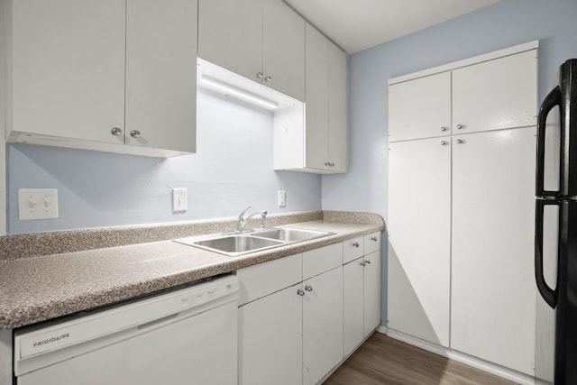 2021 Wheless Ln, Austin, TX 78723 - kitchen featuring white dishwasher, freestanding refrigerator, dark wood-style flooring, light countertops, and white cabinets