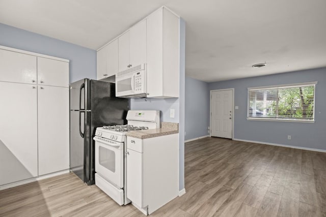 2021 Wheless Ln, Austin, TX 78723 - kitchen featuring white appliances, light wood-style flooring, light countertops, and white cabinets