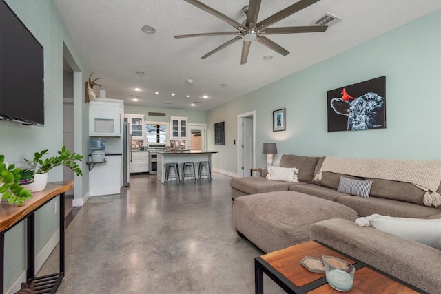 9769 Fm 1361, Snook, TX 77879 - living room with ceiling fan, recessed lighting, and finished concrete flooring