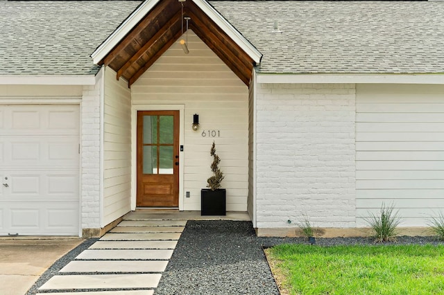 6101 Bridlington Cir, Austin, TX 78745 - doorway to property featuring a shingled roof and brick siding