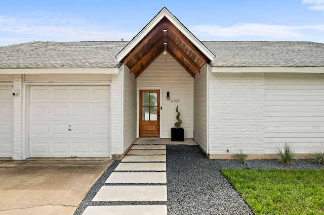 6101 Bridlington Cir, Austin, TX 78745 - property entrance with a shingled roof, brick siding, an attached garage, and driveway