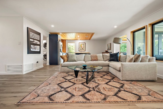 6101 Bridlington Cir, Austin, TX 78745 - living room featuring stacked washer / drying machine, wood finished floors, and recessed lighting