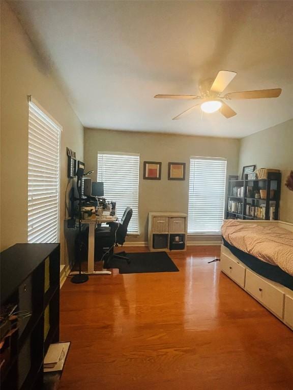 2003 Woodmont Ave, Austin, TX 78703 - bedroom with an office area, wood finished floors, and multiple windows