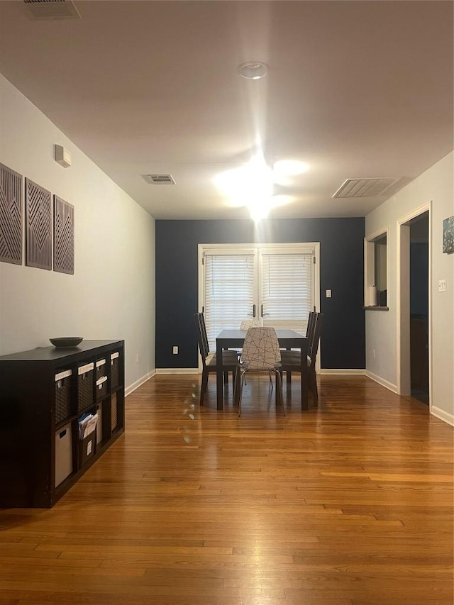 2003 Woodmont Ave, Austin, TX 78703 - dining room featuring baseboards and wood-type flooring