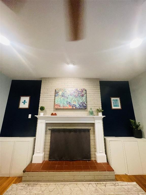 2003 Woodmont Ave, Austin, TX 78703 - detailed view of a brick fireplace and wood finished floors