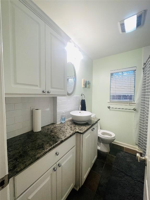 2003 Woodmont Ave, Austin, TX 78703 - full bathroom featuring vanity, tasteful backsplash, and a shower with shower curtain